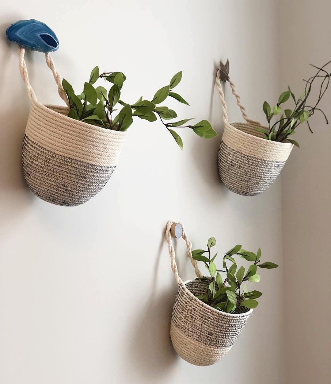 Hanging storage bags attached to a wall provide a clever storage solution to a small space by freeing floor space.