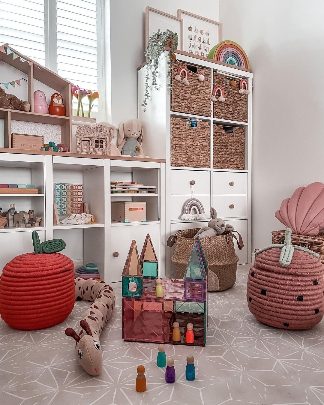 A playful and organized children's playroom with toy storage baskets, plush toys, and educational games.