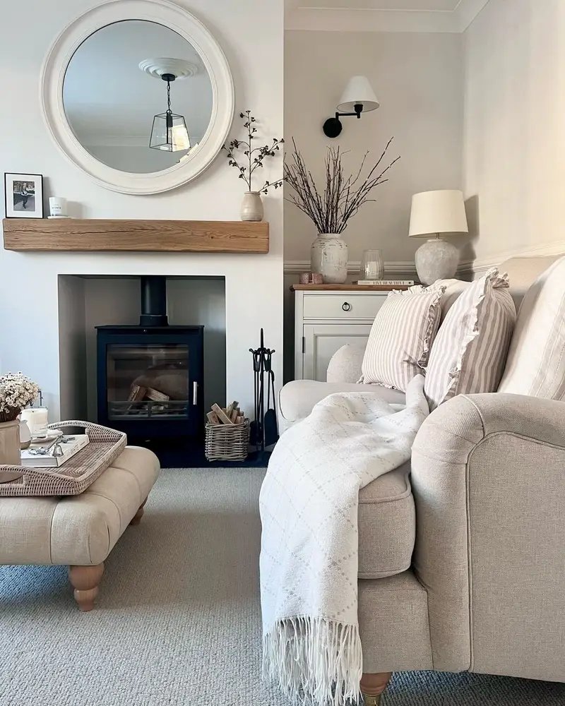 subtle striped pillow can add visual interest to a neutral living room decor like this one when paired with a nice throw blanket and styled with winter stems