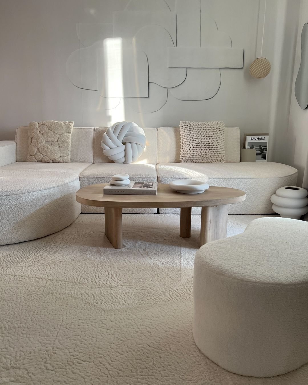 neutral color palette is a good starting point to decorating a minimalist living room such as this one with matching furniture and wall colors
